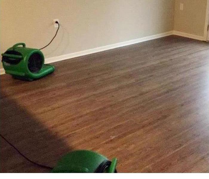 dry hardwood flooring with two green air movers placed