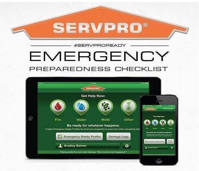 servpro people with someone holding cell phone with the app